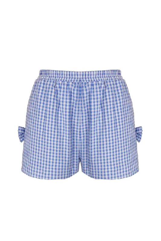 Ripped shorts – Denim or other fabric shorts with intentional tears or distressing for a rugged, trendy look.Ruby - Raquel Bow Short, Blue Gingham