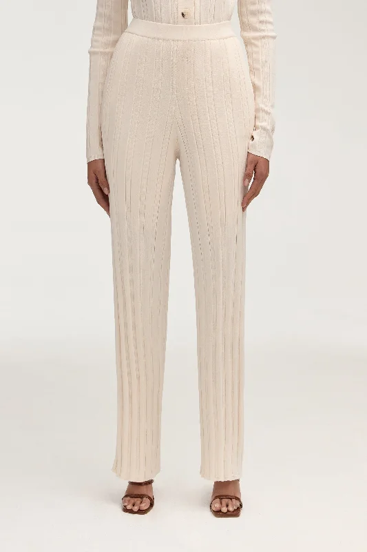 Flared trousers – Trousers with a gradual flare from the knee down, often associated with retro or 1970s fashion.Becca Knit Ribbed High Waist Pants