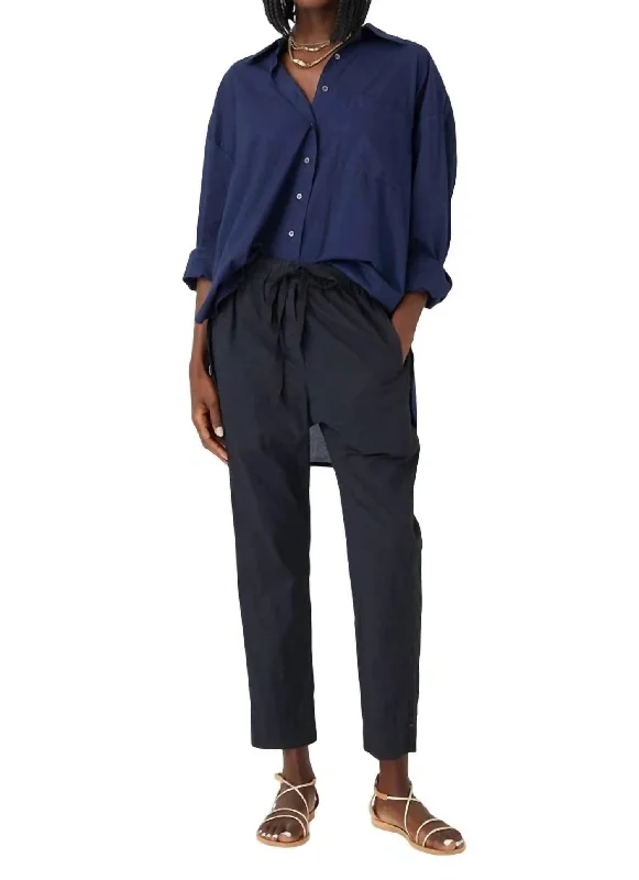 Button-front trousers – Trousers that feature a row of buttons along the waistband for a stylish detail.Draper Pant In Black