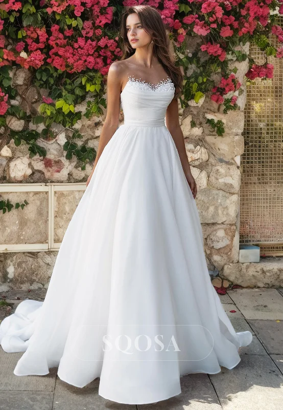 Empire waist dress – Dress with a high waistline, just under the bust, for a flattering silhouette.A Line Illusion Neckline Pearls Elegant Wedding Dress