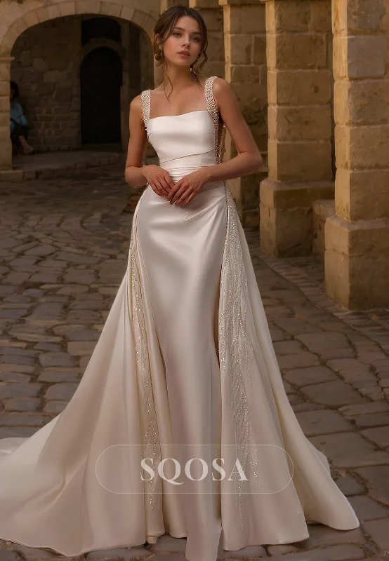 A-line dress – Dress that is fitted at the top and gradually flares out, creating an A-shape silhouette.Spaghetti Straps Square Satin Mermaid Wedding Dress with Overskirt