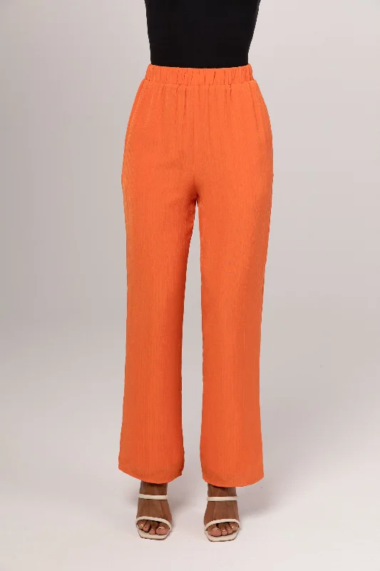 Athleisure trousers – Comfortable, performance-focused trousers that can be worn for both working out and casual wear.Nashwa Textured Rayon Wide Leg Pants - Papaya