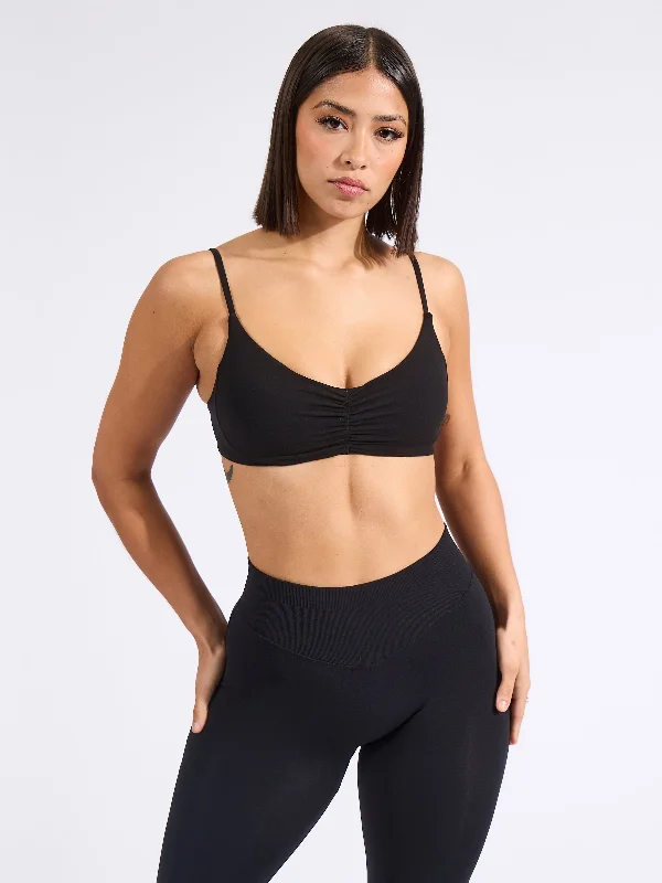 Racerback sports bra – Sports bra with a back design that features straps that meet in a "V" or "Y" shape, offering better shoulder mobility.Buttercup Sports Bra - Onyx Black