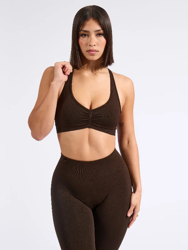 Push-up sports bra – Sports bra with added padding or structure to lift and shape the bust, providing extra support.Halter Seamless Sports Bra - Cold Brew