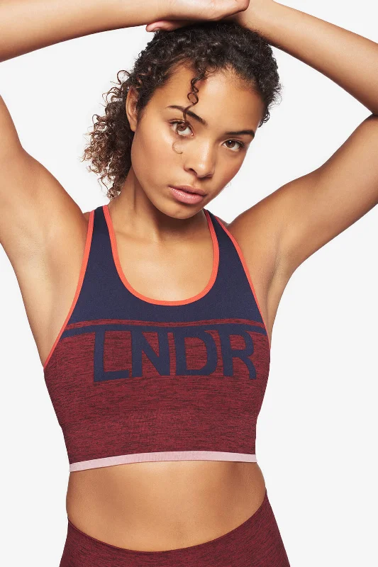 Compression sports bra – Sports bra that compresses the chest for a more secure fit and reduced bounce during high-impact activities.A-Team Sports Bra - Rust Marl