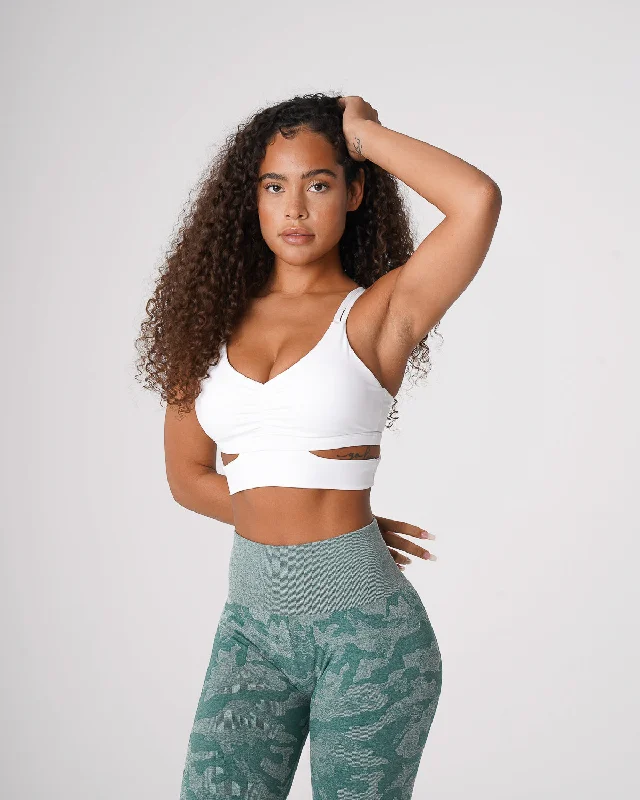 Sports bra with removable padding – Sports bra with padding that can be removed or adjusted for customized support and shape.White Revolve Bra