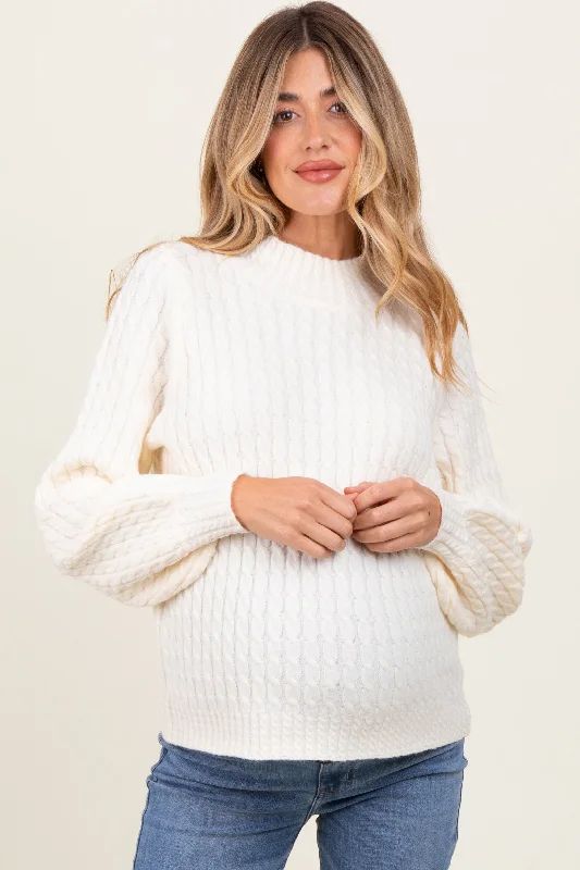 Drop shoulder – Sleeves that hang lower than the shoulder seam for a relaxed fitCream Cable Knit Mock Neck Bubble Sleeve Maternity Sweater